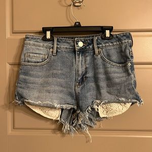 Light wash jean shorts with floral pattern pockets